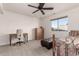 Comfortable bedroom with ceiling fan and home office area at 3818 N Lomond Cir, Mesa, AZ 85215