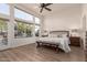 Main bedroom with a king-size bed, ceiling fan, and backyard access at 3818 N Lomond Cir, Mesa, AZ 85215