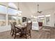 Bright dining room with a wooden table and chairs, adjacent to living room at 3818 N Lomond Cir, Mesa, AZ 85215