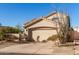 Tan two-car garage home with desert landscaping at 3818 N Lomond Cir, Mesa, AZ 85215