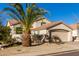 Two-story house with tan exterior, tile roof, and a palm tree in the front yard at 3818 N Lomond Cir, Mesa, AZ 85215