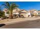 Tan two-story home with a two car garage and palm tree at 3818 N Lomond Cir, Mesa, AZ 85215