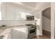 Bright kitchen featuring white cabinets and modern gas range at 3818 N Lomond Cir, Mesa, AZ 85215