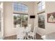 Charming kitchen nook with a white table and chairs, offering ample natural light at 3818 N Lomond Cir, Mesa, AZ 85215