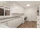 Bright laundry room with washer, dryer, and ample cabinetry at 3818 N Lomond Cir, Mesa, AZ 85215