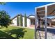 Artificial turf backyard with pergola and mature trees at 4009 W Cielo Grande Rd, Glendale, AZ 85310