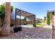 Backyard with pergola, artificial turf, and brick pavers at 4009 W Cielo Grande Rd, Glendale, AZ 85310