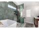 Spa-like bathroom with a freestanding tub, walk-in shower, and stylish tile at 4009 W Cielo Grande Rd, Glendale, AZ 85310