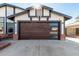 Modern garage with a sleek, dark brown door and window inserts at 4009 W Cielo Grande Rd, Glendale, AZ 85310