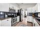 Bright kitchen featuring stainless steel appliances and dark wood countertops at 4009 W Cielo Grande Rd, Glendale, AZ 85310