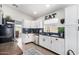 Modern kitchen with white cabinets, dark countertops, and stainless steel appliances at 4009 W Cielo Grande Rd, Glendale, AZ 85310