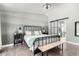 Main bedroom featuring a metal bed frame and sliding barn door to en-suite bathroom at 4009 W Cielo Grande Rd, Glendale, AZ 85310