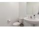 Clean and simple bathroom with pedestal sink and toilet at 40561 W Hillman Dr, Maricopa, AZ 85138