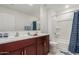 Bathroom with double vanity and shower/tub combo at 40561 W Hillman Dr, Maricopa, AZ 85138