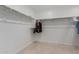 Spacious walk-in closet with double hanging rods at 40561 W Hillman Dr, Maricopa, AZ 85138