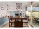 Dining area with a wooden table and sliding glass doors at 40561 W Hillman Dr, Maricopa, AZ 85138