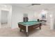 Spacious game room with a pool table and seating area for entertainment at 40561 W Hillman Dr, Maricopa, AZ 85138