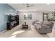 Living room with gray sectional and a blue accent wall at 40561 W Hillman Dr, Maricopa, AZ 85138