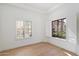 Bright bedroom featuring hardwood floors, white walls, and plantation shutters at 4430 N 22Nd St # 1, Phoenix, AZ 85016