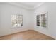 Bright bedroom featuring hardwood floors, white walls, and plantation shutters at 4430 N 22Nd St # 1, Phoenix, AZ 85016