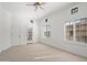 Bright bedroom with neutral carpet, a ceiling fan, and windows with plantation shutters at 4430 N 22Nd St # 1, Phoenix, AZ 85016