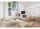 Bright living room features tall windows, a fireplace, and a modern, neutral color palette at 4430 N 22Nd St # 1, Phoenix, AZ 85016