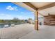 A covered patio overlooks a luxurious pool surrounded by desert landscaping and a view of the nearby mountains at 44512 N Sonoran Arroyo Ln, New River, AZ 85087