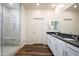 The bright bathroom features double sinks, granite countertops, and a walk-in shower with marble patterned tile at 44512 N Sonoran Arroyo Ln, New River, AZ 85087