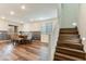 View of the wood-floored dining room leading to a staircase with white risers at 44512 N Sonoran Arroyo Ln, New River, AZ 85087