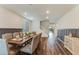 Spacious dining room features wood floors, wainscoting, and staircase in an open floor plan at 44512 N Sonoran Arroyo Ln, New River, AZ 85087