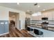 Open kitchen with white cabinetry, granite countertops, stainless steel appliances, and a stylish chandelier at 44512 N Sonoran Arroyo Ln, New River, AZ 85087