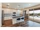 Modern kitchen with white cabinets, stainless steel appliances, and island with bar seating at 44512 N Sonoran Arroyo Ln, New River, AZ 85087