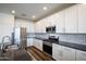 Close up on the kitchen with stainless steel appliances, and granite countertops at 44512 N Sonoran Arroyo Ln, New River, AZ 85087