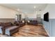 Cozy living room with wood-look floors, wainscoting, and comfortable sofas at 44512 N Sonoran Arroyo Ln, New River, AZ 85087