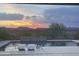 View of pool and sunset over desert landscape at 44512 N Sonoran Arroyo Ln, New River, AZ 85087