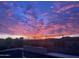 Sunset over the desert landscape with a pool in the foreground at 44512 N Sonoran Arroyo Ln, New River, AZ 85087