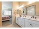 Bathroom with double vanity and view into the bedroom at 4466 N 200Th Ln, Litchfield Park, AZ 85340