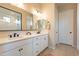 Modern bathroom with double vanity and a large mirror at 4466 N 200Th Ln, Litchfield Park, AZ 85340