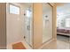 Modern bathroom with a large walk-in shower, tile flooring, and a single window at 4466 N 200Th Ln, Litchfield Park, AZ 85340