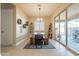 Rustic dining area with wooden table and bench seating, plus sliding glass doors at 4466 N 200Th Ln, Litchfield Park, AZ 85340