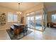 Bright dining area with wooden table, bench, and access to a patio at 4466 N 200Th Ln, Litchfield Park, AZ 85340