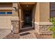 Inviting front entrance with a stone walkway and a dark wooden door at 4466 N 200Th Ln, Litchfield Park, AZ 85340