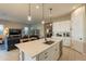 Bright kitchen with white cabinets, island, and stainless steel appliances at 4466 N 200Th Ln, Litchfield Park, AZ 85340