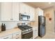 Modern kitchen with stainless steel appliances and white cabinets at 4466 N 200Th Ln, Litchfield Park, AZ 85340