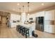 Modern kitchen with white cabinets, stainless steel appliances, and an island at 4466 N 200Th Ln, Litchfield Park, AZ 85340