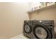 Bright laundry room with Samsung washer and dryer and shelving at 4466 N 200Th Ln, Litchfield Park, AZ 85340