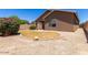 Landscaped backyard with a grassy area and gravel at 44899 W Portabello Rd, Maricopa, AZ 85139