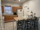 Cozy kitchen with breakfast bar, wood cabinets, and white appliances at 44899 W Portabello Rd, Maricopa, AZ 85139