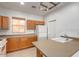 Well-lit kitchen with wood cabinets, white appliances, and large island at 44899 W Portabello Rd, Maricopa, AZ 85139