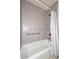 Clean bathroom with shower/tub combo and gray tile at 5100 N Miller Rd # 20, Scottsdale, AZ 85250